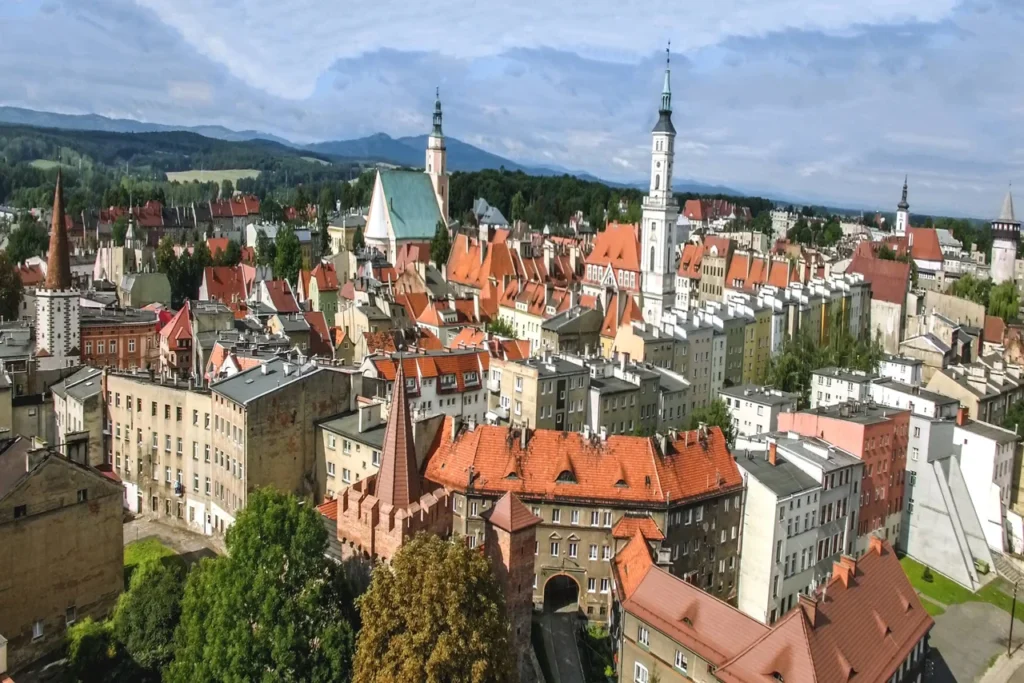 Panorama Prudnika z widocznym centrum miasta na pierwszym planie i pasmem Gór Opawskich w tle